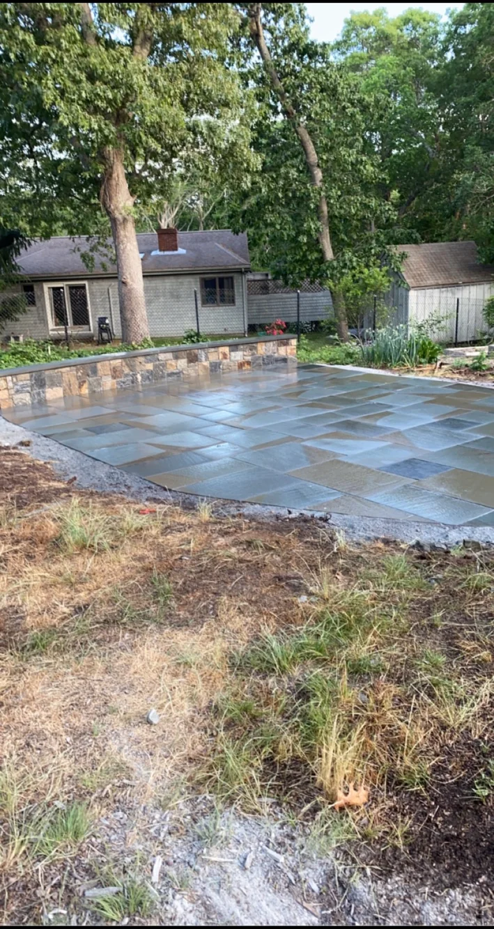 Bluestone patio with stone wall